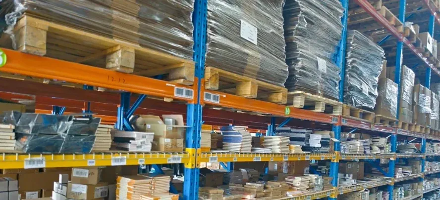 Wrapped stock and labeled cartons on warehouse racks